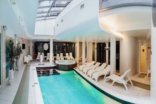 Swimming pool and lounge area at Wellton SPA Centrum in Riga